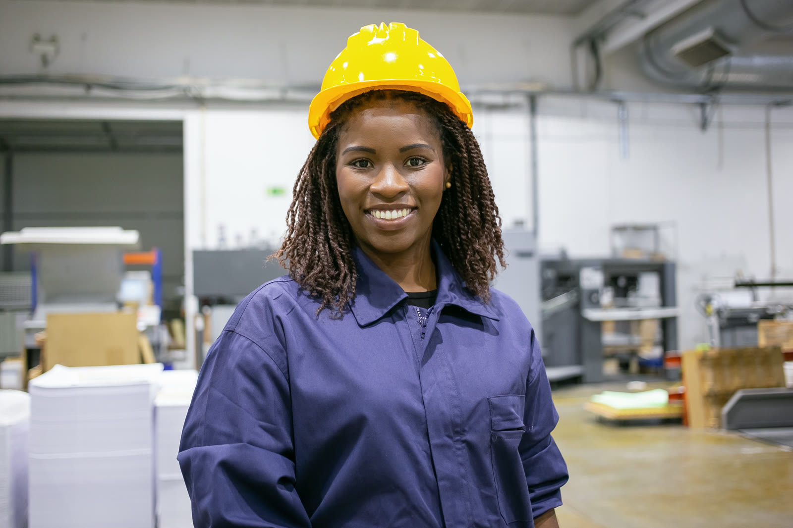 PPE Suppliers staff member wearing custom-manufactured workwear on the Nairobi factory floor